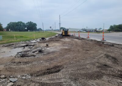 Skid loader tearing out concrete on roadway