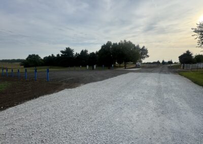 Gravel parking lot with handicap signage and roadway
