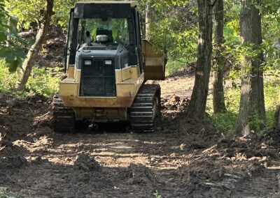 CAT dozer working site prep project in wooded area