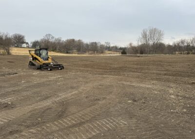 Skid steer with pulverizer attachment working a soil prep project