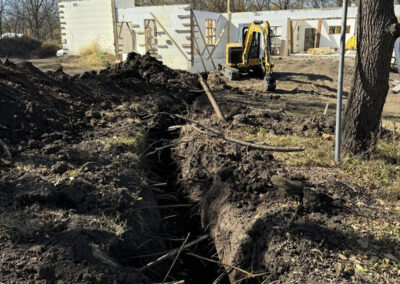 Trenching with backhoe in West Des Moines
